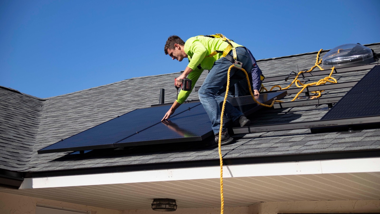 Professional installing solar panels on a home